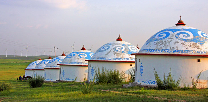 Mongolian Yurts or Mongolian houses in Inner Mongolia on grassland with power lines in the background