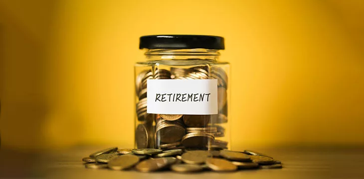 Glass jar with retirement label with gold coins inside