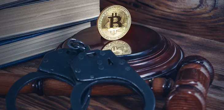 Justice concept. Bitcoin, judge's hammer, handcuffs