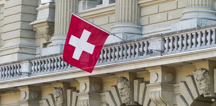 Swiss parliament building Bundeshaus Facade with Swiss Flag in Bern, Switzerland