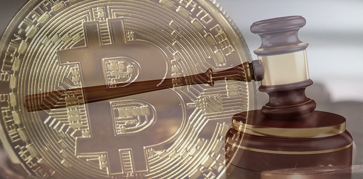 Photo of a digital currency against a gavel