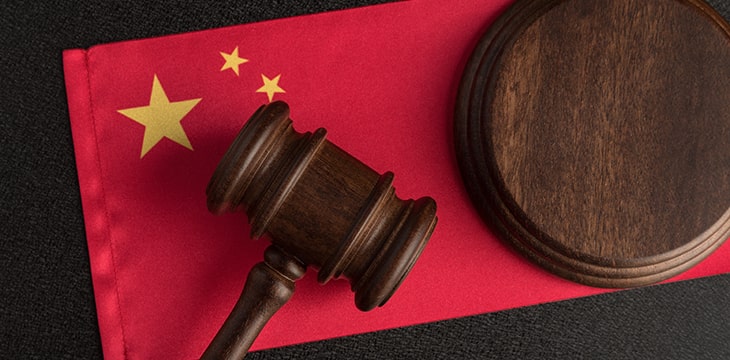 Chinese flag beside a gavel. Concept of law enforcement