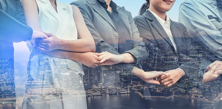 Double exposure business people handshake agreement with cityscape in background. Business executive meeting and collaboration.