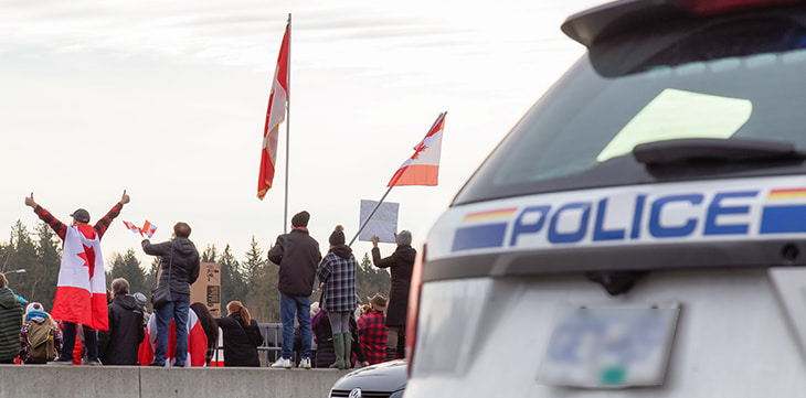 People on the Highway Overpass Supporting the Freedom Rally and the protest of the Truck Drivers against Vaccine Mandate