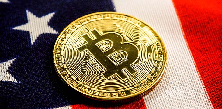 Crypto currency bitcoin btc golden bit coin against flag of United States of America USA. Virtual money, blockchain business, internet finances concept.