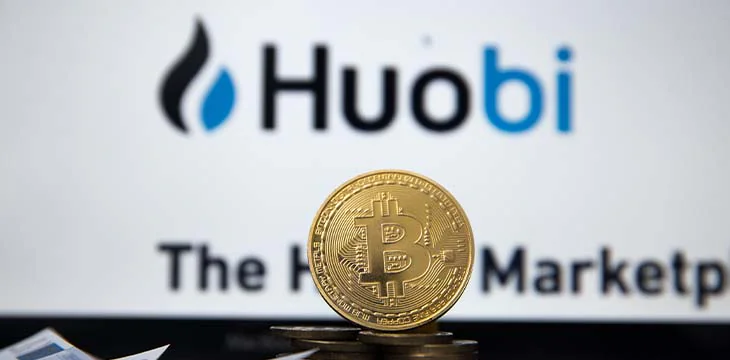 Tula, Russia - JANUARY 27, 2019: bitcoins, dollars and Huobi logo on the screen smartphone. Huobi - one of the largest cryptocurrency exchange