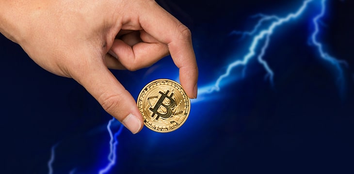 Bitcoin coin in front of lightning