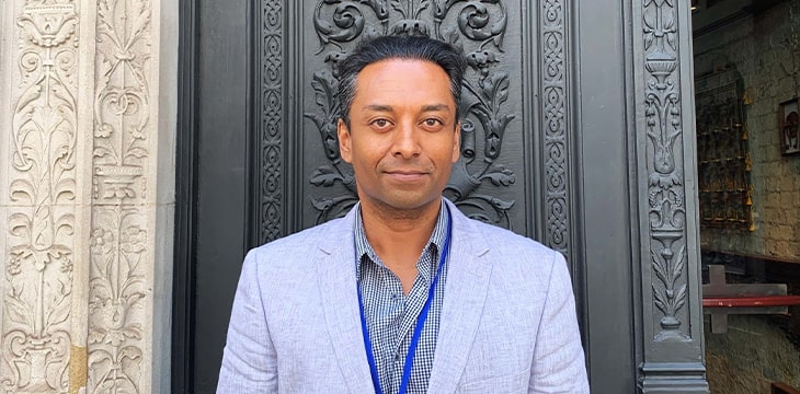 man in suit in front of door