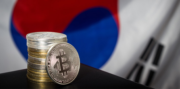 Stack of bitcoins over flag of South Korea