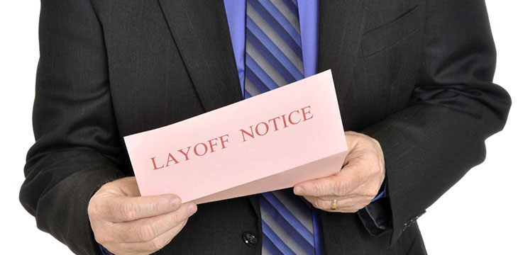 Person holding a paper with "Layoff Notice"