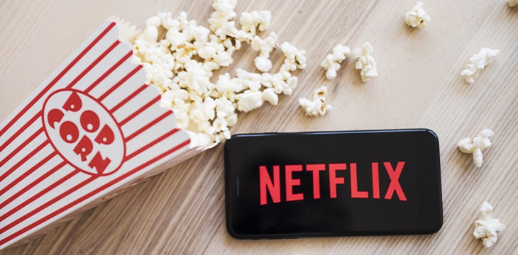 popcorn beside phone with netflix