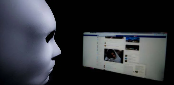 You never know who is behind your screen. Anonymous mask to hide identity in front of a computer - internet criminal and cyber security threat concept. — Photo