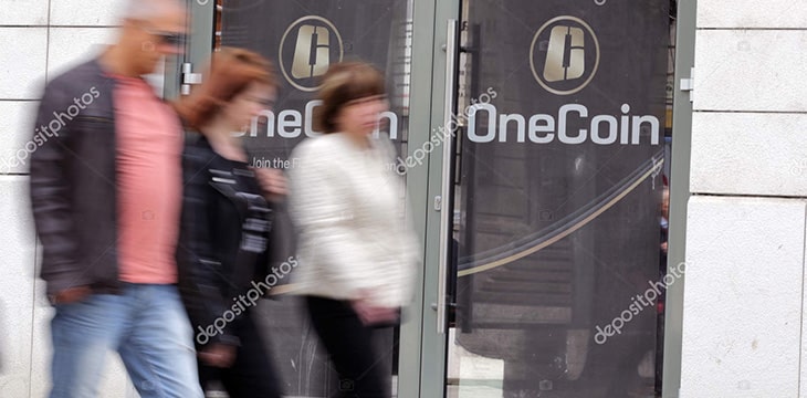 OneCoin company with people passing by