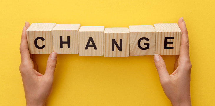 Cropped view of woman holding wooden cubes incripted with the word "change"