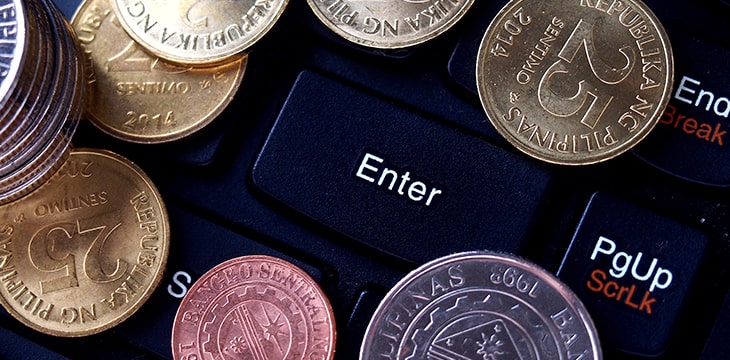 Coins on the keyboard of a laptop computer