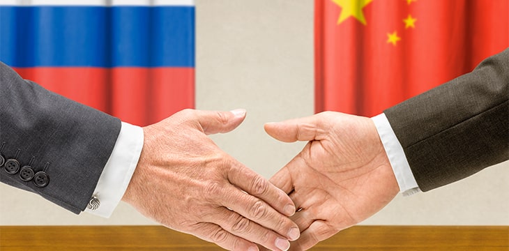 Representatives of Russia and China shake hands