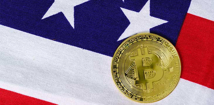 Crypto currency concept. Gold Bitcoin coin on flag of United States of America USA