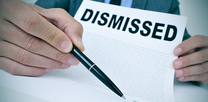 Businessman shows a document with the text dismissed.