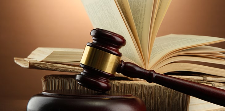 Wooden gavel and books on wooden table