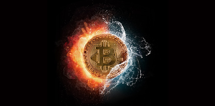 Burning Bitcoin crypto currency symbol with water splashes