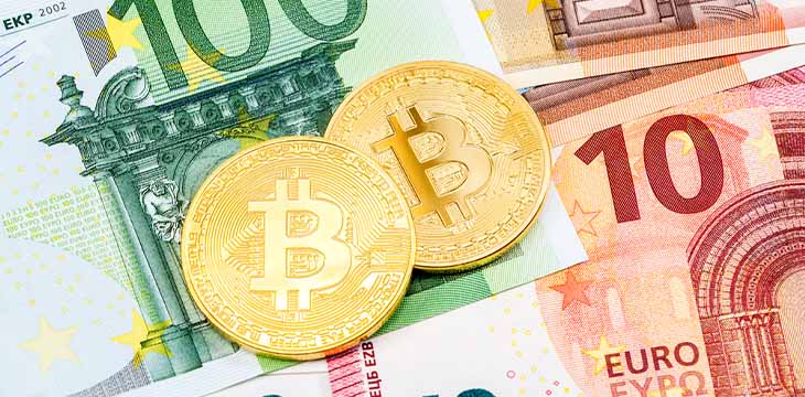 crypto coins on euro banknotes