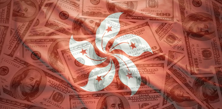 Colorful waving hong kong flag on a American dollars