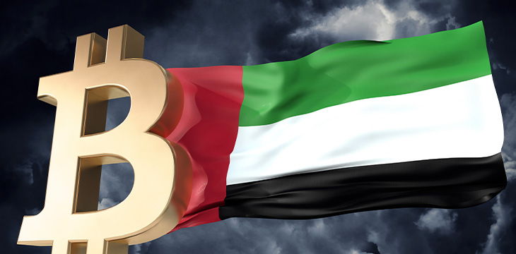 Gold bitcoin cryptocurrency with a waving UAE flag