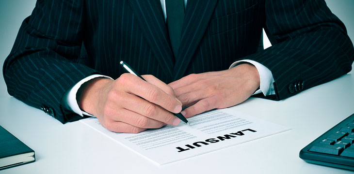 Lawsuit word on document being read and signed by a man in a business corporate suit