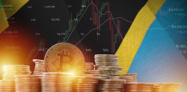 Tanzania flag and big amount of golden bitcoin coins and trading platform chart.