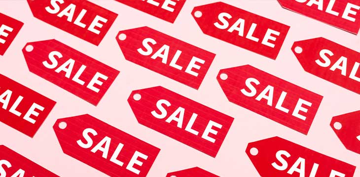 Top view of labels with sale lettering on pink, black friday concept