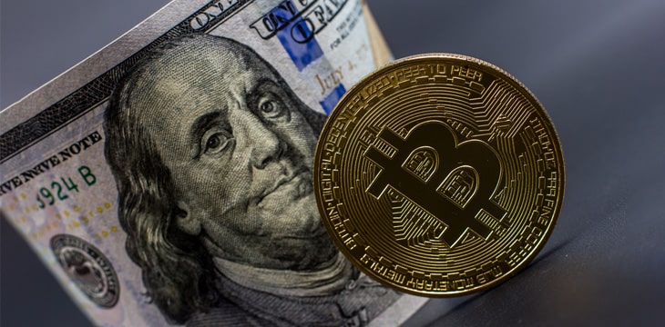 Bitcoin and a dollar bill