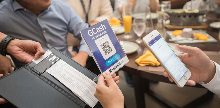 Customer uses his smartphone to pay for bill using Gcash