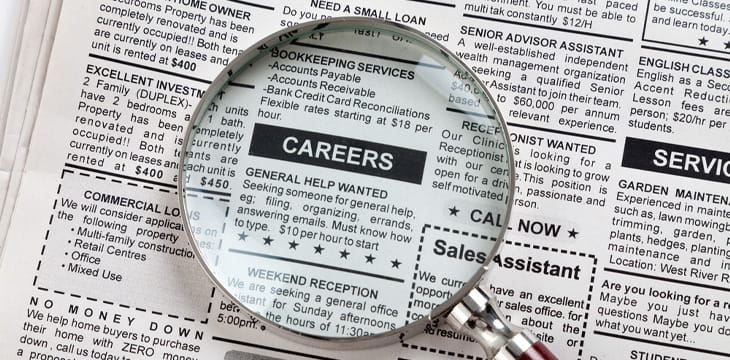 Career ad in a newspaper with magnifying glass