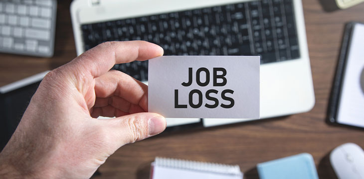 Male hand showing Job Loss text on business card