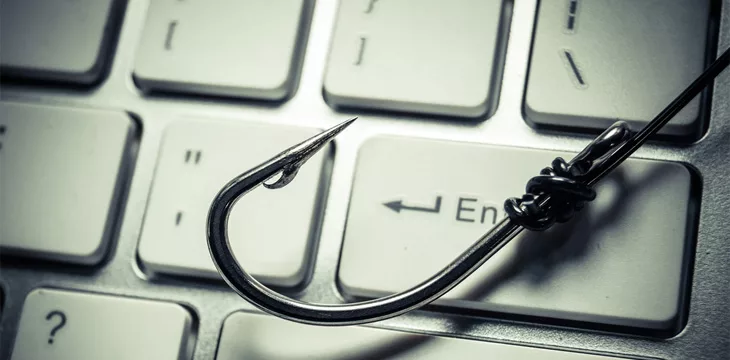 A fish hook on computer keyboard