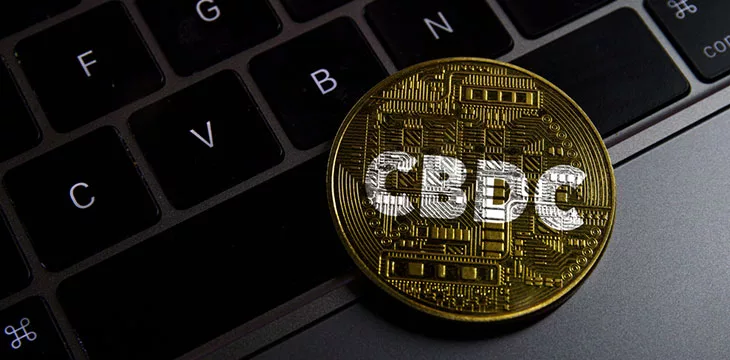 Central bank digital currency coin on laptop keyboard