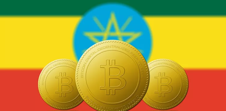 Three Bitcoins cryptocurrency with Ethiopia flag on background