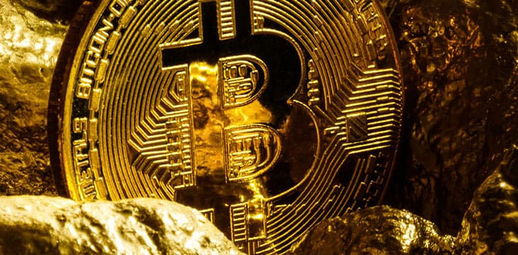 Golden bitcoin coin and mound of gold bitcoin cryptocurrency business