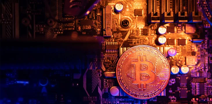 Bitcoin Cryptocurrency coin on a PC computer motherboard, crypto currency mining concept