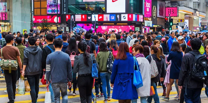 Crowds of unidentified people crossing King's Road in HK Island