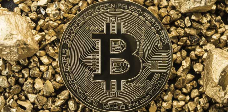 Golden Bitcoin Coin with gold. Bitcoin cryptocurrency. Business concept.