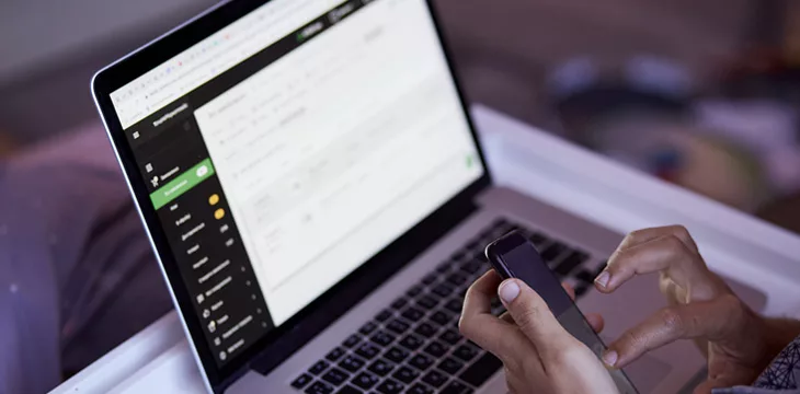 Man uses his laptop and phone for work and business at home.