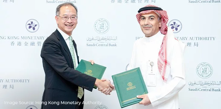 Ayman Alsayari and Eddie Yue doing a handshake