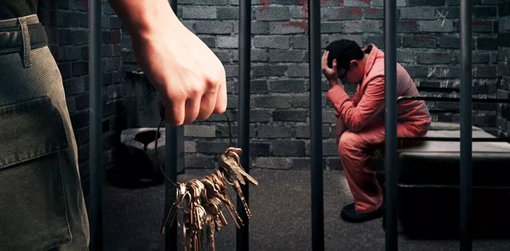 prison cell and a guard holding keys