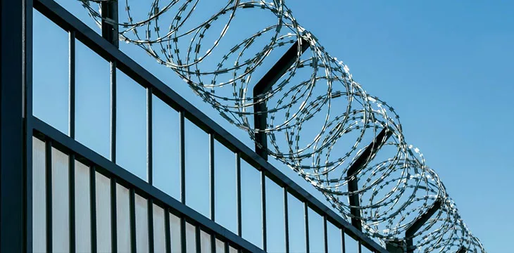 Iron fence with barbed wire