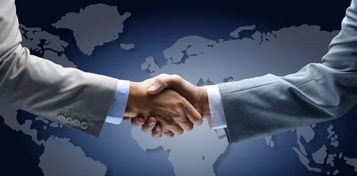 hand shake with world map background