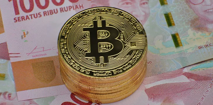 Physical version of Bitcoin and Indonesia Rupiah banknotes