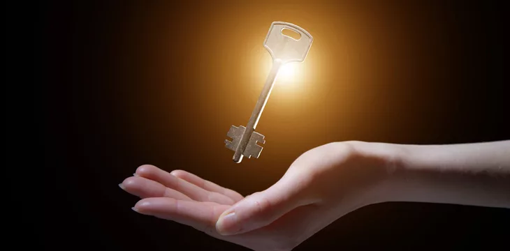 Human hand with shining key