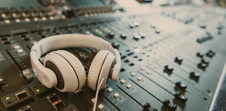 Close-up shot of headphones on graphic equalizer