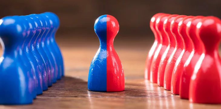 Two Rows Of Pawns Coming Together And Merging On Wooden Table